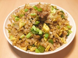 14、肥牛炒饭,翻炒均匀后,即可盛出,撒上葱花和白芝麻,香喷喷的肥牛炒饭做好了,开吃吧!