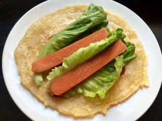 15、火腿鸡蛋生菜卷饼,放上加热好的火腿肠