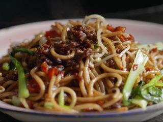 6、江西炒粉, 再将米粉放入翻炒,淋适量酱油,随后放入20克小青菜、20克绿豆芽炒至断生,最后加盐调味,炒干水分即可。