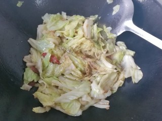 11、腊肠手撕包菜,再调入适量胡椒，鸡精炒均匀；