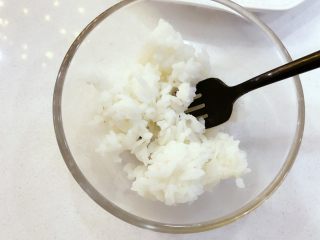 3、宝宝辅食:宝宝芒果饭-12M+ ,将奶倒入米饭中,用叉子混合均匀。