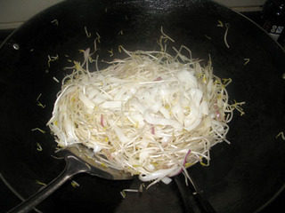 8、干炒牛河,把绿豆芽和河粉拌匀,炒到绿豆芽稍微变软即可。