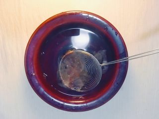 5、味噌鸡肉丸日式火锅,将水烧开,关火。放入鲣鱼花,待其自然沉入水底。过滤掉鲣鱼花。