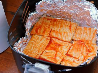3、香辣烤豆腐,在九阳空气炸锅的炸篮里放入一块锡纸，在锡纸上刷一层蒜蓉辣酱，把切好的豆腐码在炸篮里。刷上蒜蓉辣酱。