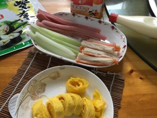 2、寿司,蟹肉棒需蒸5分钟左右，鸡蛋煎好切条，其他材料如图切条备用。