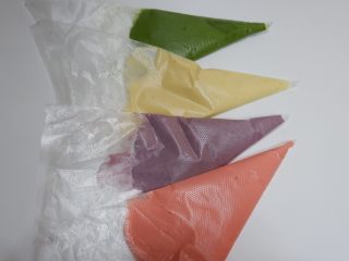 25、彩虹蕾丝蛋饼,四个颜色都装好了。将裱花袋剪出一个小口，排列好你要搭配颜色顺序放好。避免一会手忙脚乱