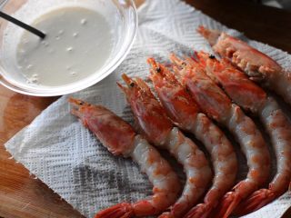 4、炸虾寿司卷,把处理好的阿根廷红虾放在厨房用纸上沥干多余的水份后，裹上调好的天妇罗面糊；