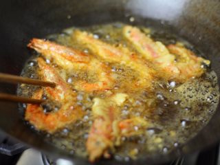 5、炸虾寿司卷,接着油温热至180度以上，下裹好面糊的虾油炸，要炸制虾头酥透哦；