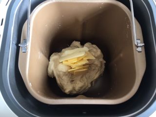 3、黄桃椰蓉心形面包,然后加入提前软化的黄油，继续揉面