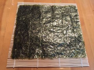 6、紫菜包饭,将寿司紫菜放在寿司帘上
