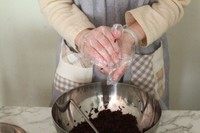 13、紫米芝士肉松饭团,把饭团捏紧后开始整形。拿饭团的手,手掌根和手指同时用力。想象一下这个动作:单手将饭团压扁成圆饼状。另一只手整排手指和手掌呈90°,捏住饭团顶部,手指向手掌方向用力,捏出饭团的三角形状。