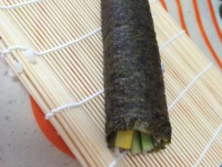 4、寿司,从卷帘的一侧顺势卷起，卷的时候用力，切的时候才不会散。