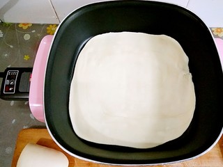 13、鸡蛋灌饼,电锅档位按在小火上,把擀好的面饼放进锅中(不粘锅来的,都不用放油哦!)