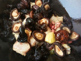 8、超美味的黄焖鸡,翻炒一会儿再放入花生米、木耳和香菇翻炒