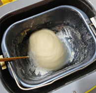 1、绣球面包,面包桶中加入牛奶+2个全蛋共280克，加入面粉、糖、盐、酵母，按按揉面档把面揉一遍