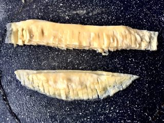 12、金菊西米寿司,将切好的蛋皮边缘弧形的两张叠好，另外4张叠好。不切断地切边缘成流苏，大致一小条2-2.5mm。太粗看不出菊花，太细支撑不起来立体。