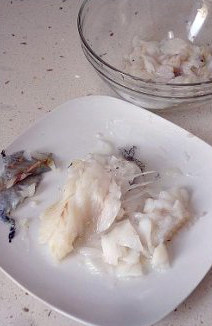 3、创意西餐：让小朋友喜爱的烤鳕鱼饼 ,捞出鳕鱼，用筷子将鱼肉剔到另一个碗中。