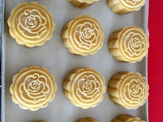 9、广式绿豆沙蛋黄月饼+#中秋食饼记#,做好的月饼排放在烤盘上,刷蛋液,月饼外皮喷水,以防在烘烤的过程中开裂。