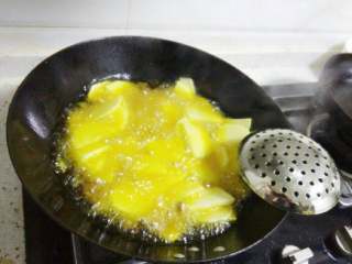 3、干锅土豆片,把土豆放油锅里中火炸,等表面变金黄时捞出控油备用 。