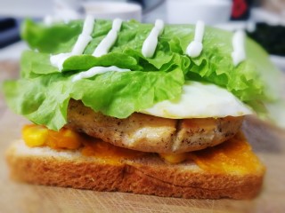 16、甜玉米鸡胸肉全麦三明治,放上两片生菜，挤上适量沙拉酱。