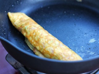 8、芝士培根鸡蛋卷,从一面慢慢把蛋皮卷起来