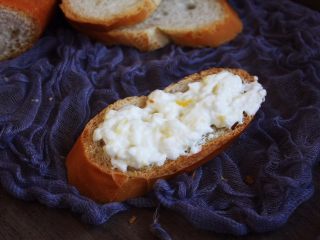 13、百变水果 柠香酸奶佐蜂蜜烤梨配法棍面包,将步骤11准备好的柠香酸奶涂抹在面包上。