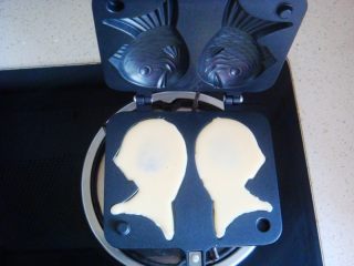 13、蔓越莓鲷鱼烧,再挤入糊糊把周围填满。合上模具一分钟左右翻面，中间可以打开观察下颜色。