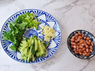 2、凉拌粉丝,花生米洗净控干水分,青瓜切成丝,蒜切末,葱切葱花,香菜切寸段