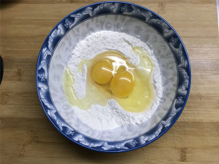 3、茼蒿鸡蛋饼,面粉放入大碗中，加入少许的盐拌匀，再把2个鸡蛋打入。