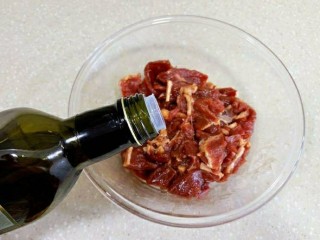 13、黑椒牛肉披萨,加入橄榄油,充分抓均,这步非常重要,是保证牛肉嫩滑的关键,抓均后腌制2小时