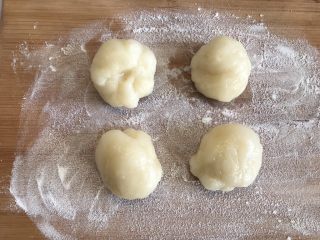 12、芒果雪媚娘,撒上点熟的糯米粉,取出冷藏好的面团,分成四份