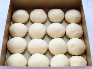 7、养乐多淡奶油小餐包,将松弛好的面团揉圆排放烤盘内