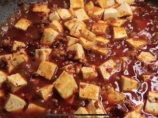 5、麻辣鲜香的麻婆豆腐,辣椒粉、青花椒粉翻炒均匀，下料酒炒干，适量生抽，下豆腐，用铲背推动均匀。下一碗高汤或清水，咕噜5分钟