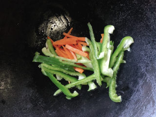 5、青椒肉丝面,加入胡萝卜丝、青椒丝炒至变软。