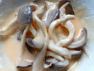 8、孜然蘑菇,将平菇放入鸡蛋糊中裹上一层面糊