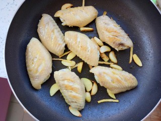 11、蒜香红烧鸡翅,把鸡翅煎到两面金黄