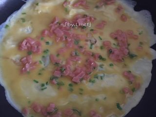 6、火腿蒜香鸡蛋卷,接着平底锅烧微热，中小火。放入少许油（也可不放）看自己的锅粘不粘而定。倒入适量拌好的鸡蛋液