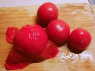3、番茄豆腐汤,番茄用开水烫一下容易剥皮  切小块备用。