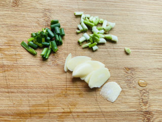 4、平菇豆腐汤,蒜头去皮切成片、香葱洗净切圈
