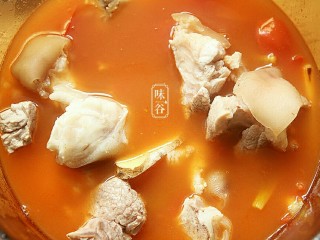 9、番茄黄豆猪蹄汤,把煮好的番茄汤汁转入炖锅内,先后倒入猪蹄。