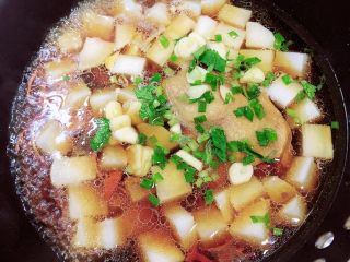 12、老鸭粉丝汤,放入葱蒜，继续炖煮。