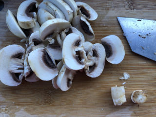 3、蘑菇炖豆腐,去蒂切成片备用。