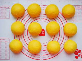 7、南瓜香肠麦穗面包,面团放在垫子上平均分成100克一个的小剂子排气揉圆。