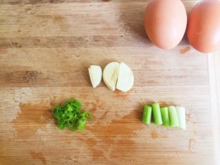 6、番茄鸡蛋面—家的味道,蒜拍碎，葱白部分切段，葱叶切成葱花。因为这里葱和蒜只是借味，所以没有切很碎。