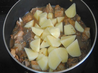 6、土豆烧肉,开盖子放入土豆翻炒均匀，再盖上盖子焖煮10-15分钟即可；