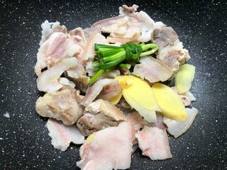6、腌笃鲜,把焯好的新鲜五花肉、咸排骨、咸五花肉清洗干净，放入汤锅里，再放入姜片和葱结。