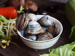 3、十味  海鲜（白蚬子）豆腐大酱汤,将买来的白蚬子全部放进一个盆子里，然后在水里加一点菜油。被菜油覆盖的一部分水与空气隔绝，贝类会因为缺氧把身体伸出来呼吸，这样就达到了清洗的效果。但需要注意的是，菜油合适就可以了，不能加太多，以免白蚬子窒息死掉。白蚬子一定要选活的，这样好去沙，而且更鲜美。