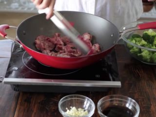 7、15分钟一道家常西兰花炒牛肉,加入腌制好的牛肉，让牛肉铺在锅的整个表面
