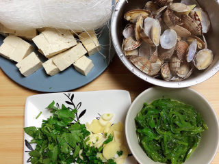 4、花蛤豆腐汤,豆腐切块儿、配菜切碎，就可以开始制作美食了。