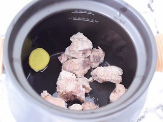 3、排骨萝卜汤,把排骨和姜片放入砂锅中